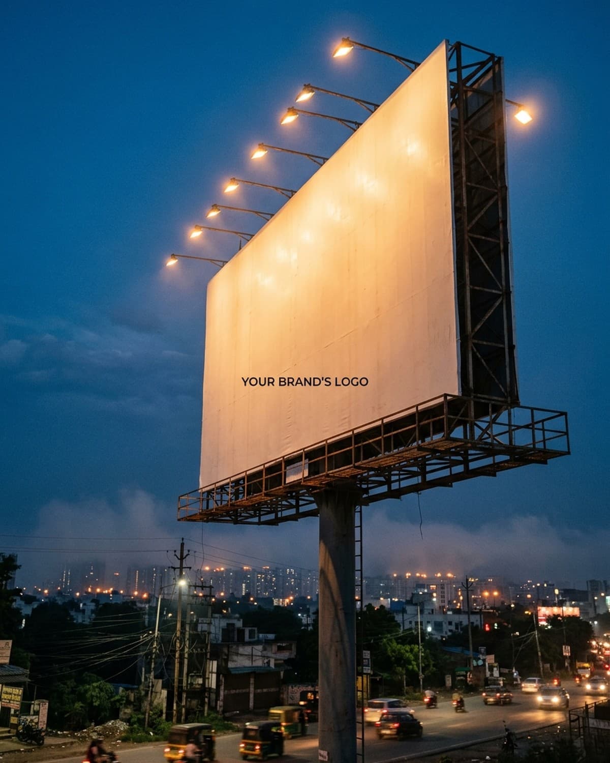 A huge billboard lit by amber floodlights at dusk, blank except for a small placeholder where your brand's logo goes.